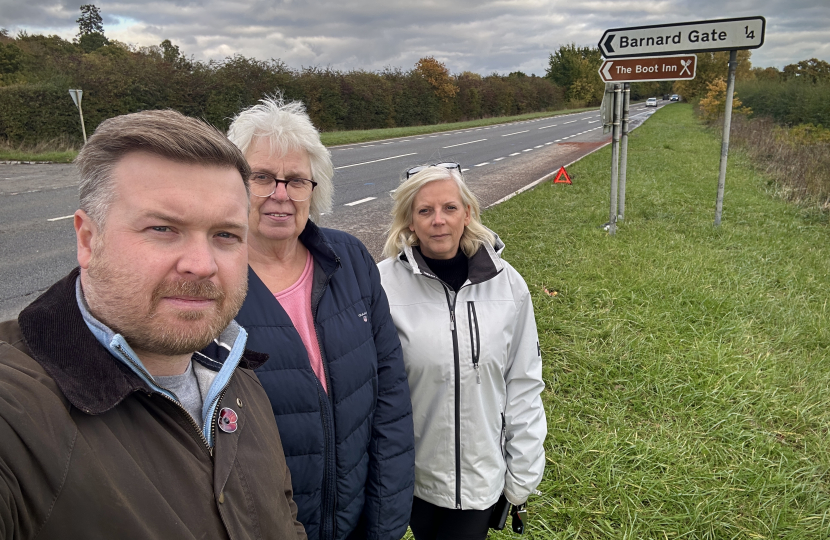 Cllr Liam Walker with South Leigh Parish Council chair Nicky Brooks and Vice Chair Lysette Nicholls by the A40 Barnard Gate junction. 