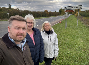 Cllr Liam Walker with South Leigh Parish Council chair Nicky Brooks and Vice Chair Lysette Nicholls by the A40 Barnard Gate junction. 